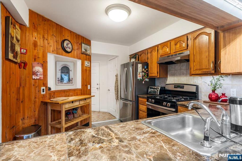 48 Quartz Lane Paterson, NJ 07501 - Photo 3 of 29 a kitchen with stainless steel appliances granite countertop a stove refrigerator and a sink