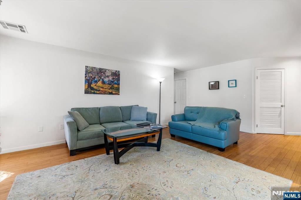 48 Quartz Lane Paterson, NJ 07501 - Photo 6 of 29 a living room with furniture and a wooden floor