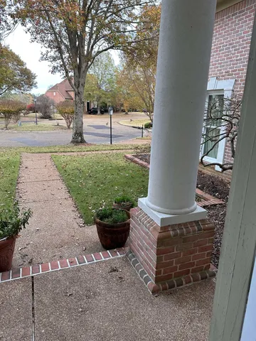 a view of a backyard with sitting area