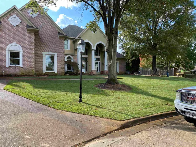 a front view of a house with a yard