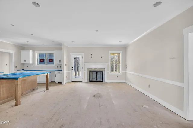 a view of a livingroom with a fireplace and window