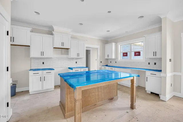 a kitchen with white cabinets and white appliances
