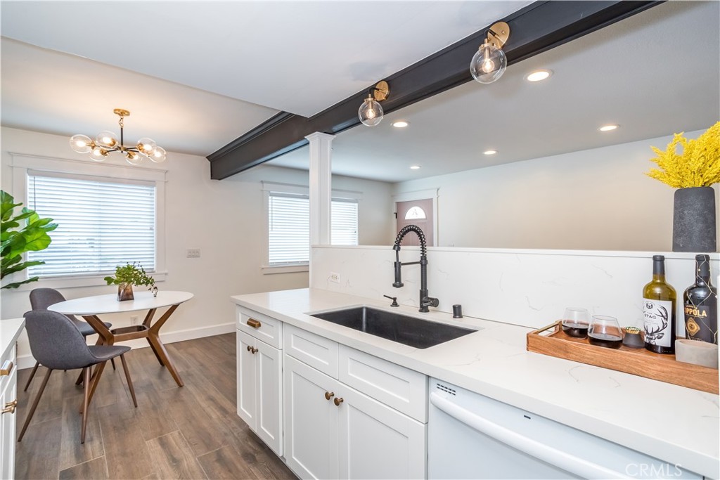 a kitchen with sink and view of living room