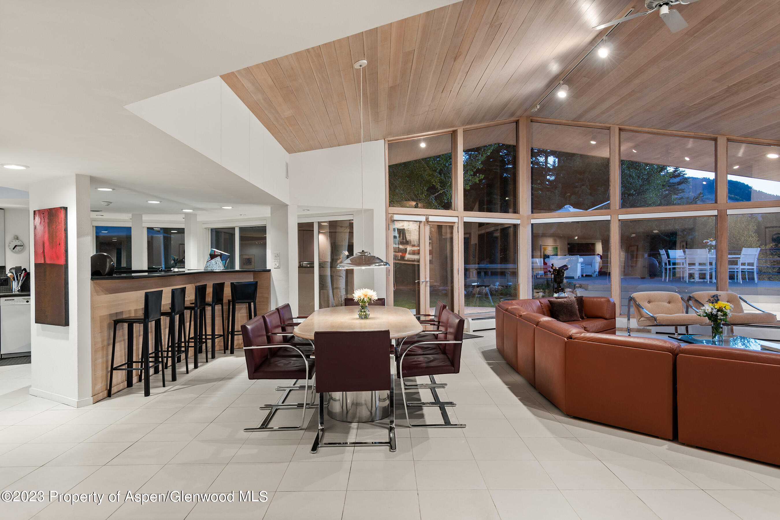 695 Meadows Road Aspen, CO 81611 - Photo 14 of 18 a living room with furniture a large window and kitchen view