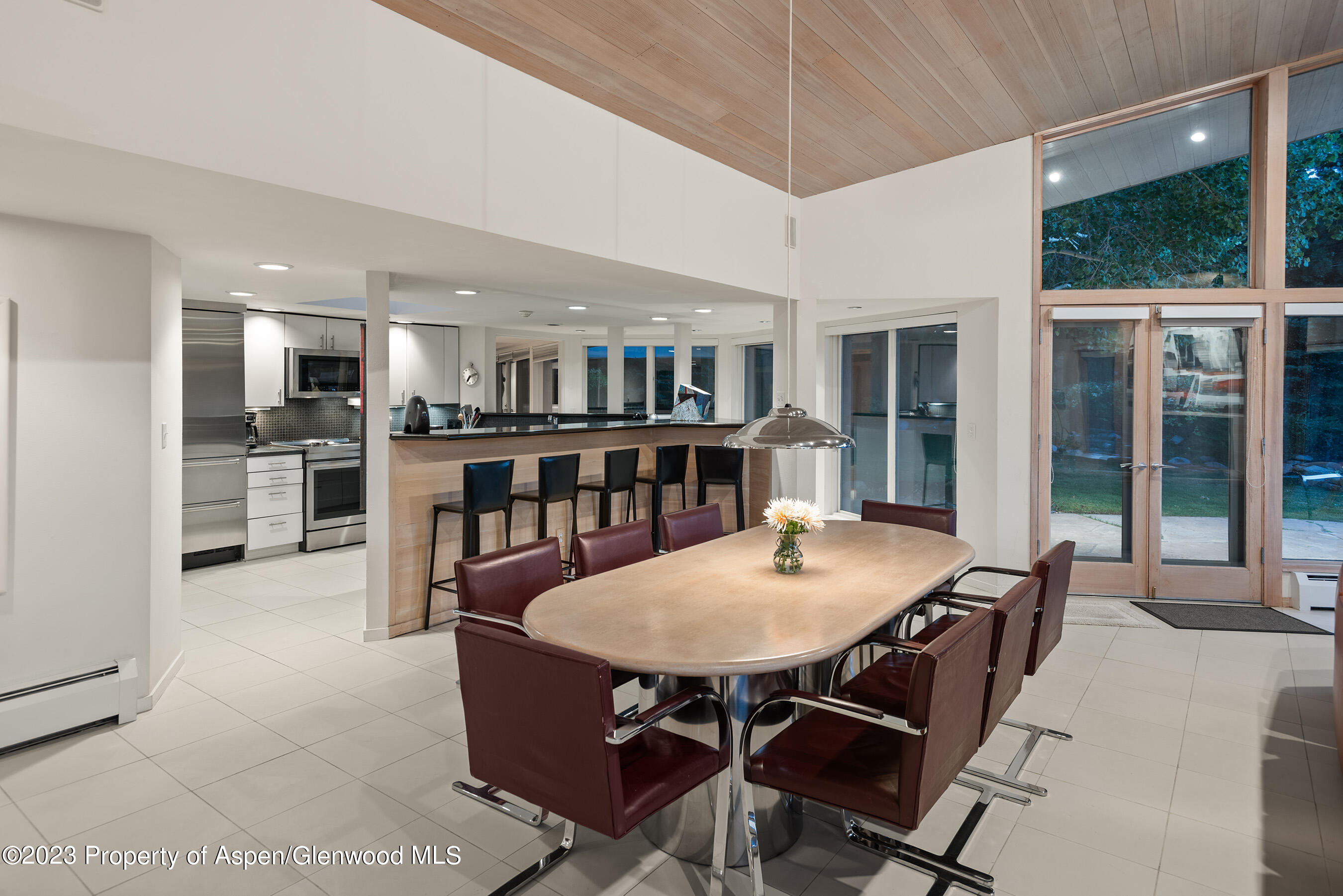 695 Meadows Road Aspen, CO 81611 - Photo 15 of 18 a view of a dining room with furniture window and wooden floor