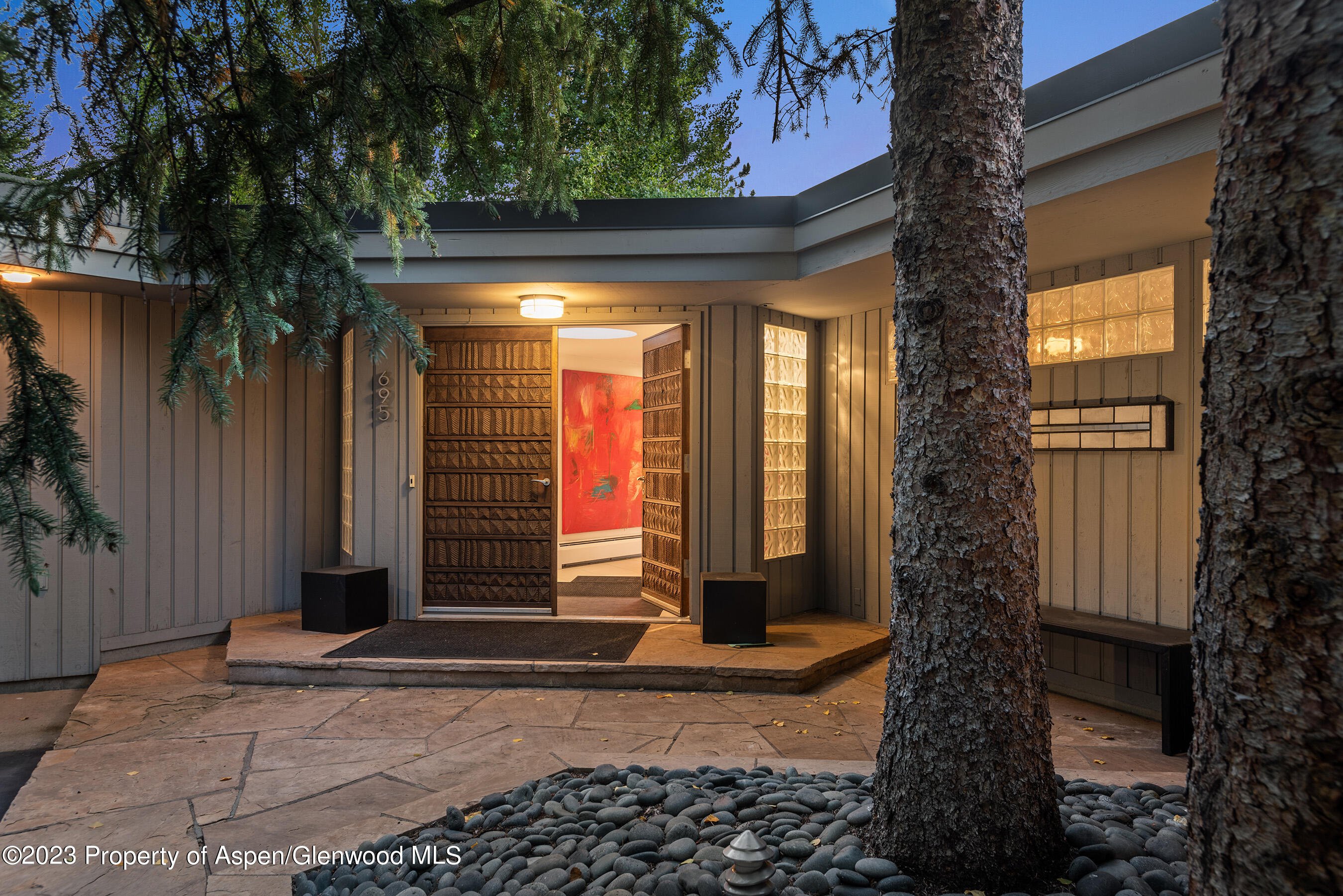 695 Meadows Road Aspen, CO 81611 - Photo 2 of 18 a front view of a house with a yard and garage
