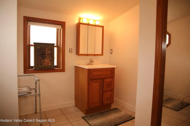 a bathroom with a sink a toilet and mirror