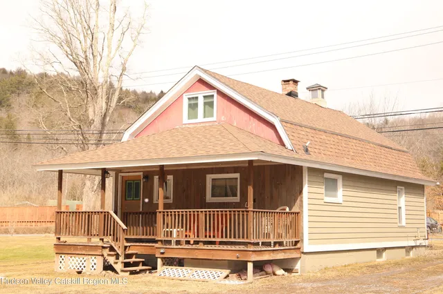 a view of a house with wooden fence