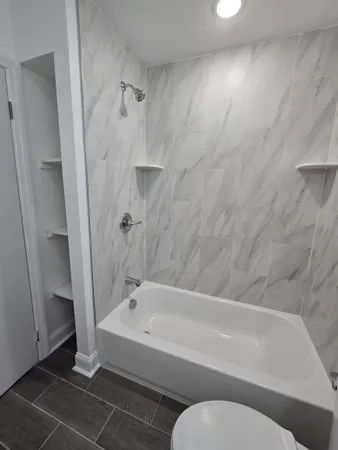 a bathroom with a bathtub and a shower