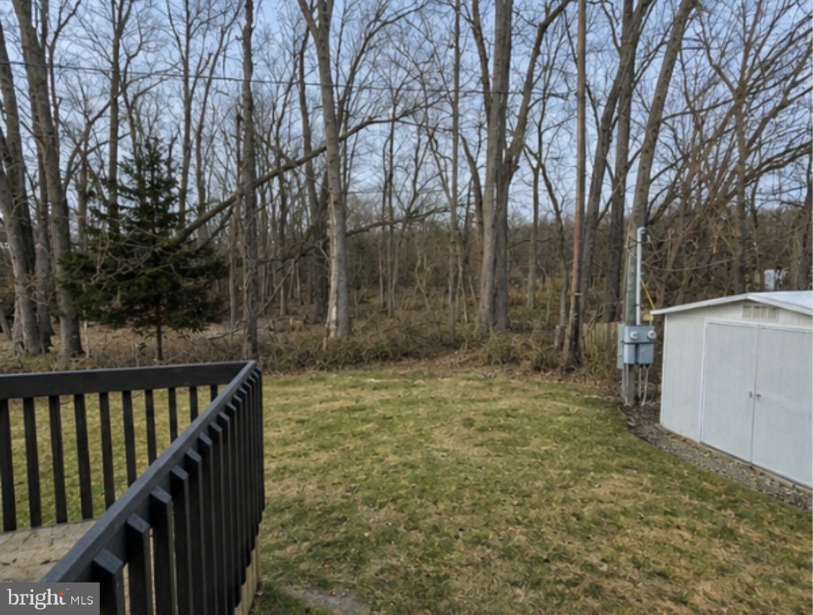194 Jacobstown New Egypt Road, Unit 2 Wrightstown, NJ 08562 - Photo 3 of 17 Serene backyard with wooded backdrop.