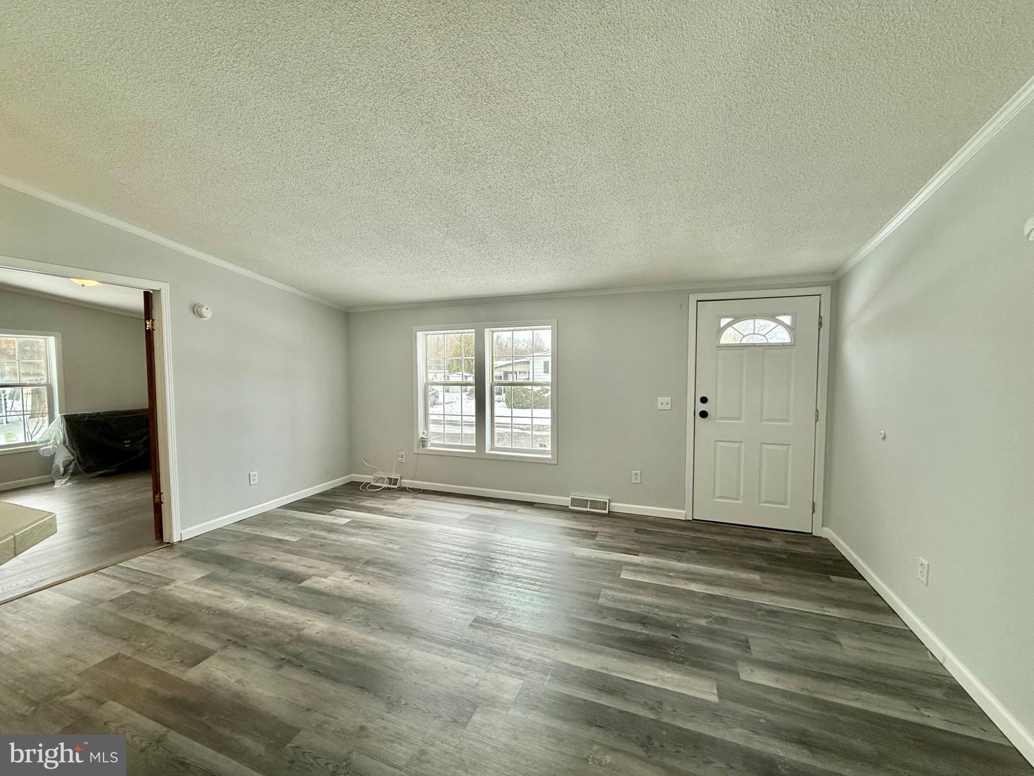 194 Jacobstown New Egypt Road, Unit 2 Wrightstown, NJ 08562 - Photo 5 of 17 a view of an empty room with wooden floor and a window