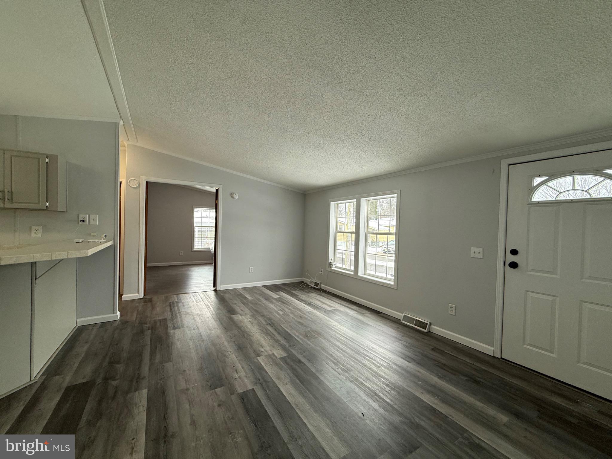 194 Jacobstown New Egypt Road, Unit 2 Wrightstown, NJ 08562 - Photo 6 of 17 a view of an empty room and window and wooden floor