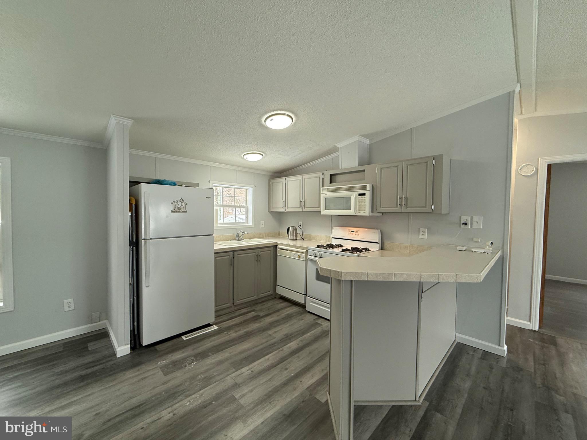 194 Jacobstown New Egypt Road, Unit 2 Wrightstown, NJ 08562 - Photo 9 of 17 a kitchen with a sink a refrigerator and white cabinets
