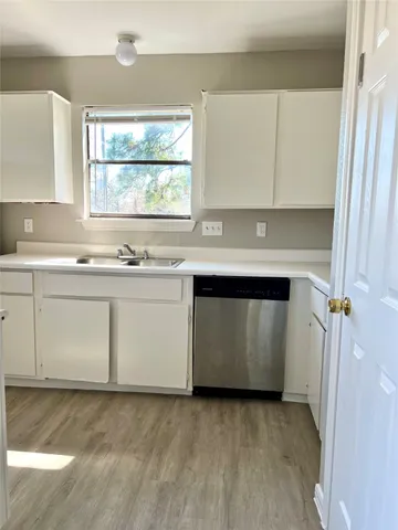 a kitchen with a sink stove and cabinets
