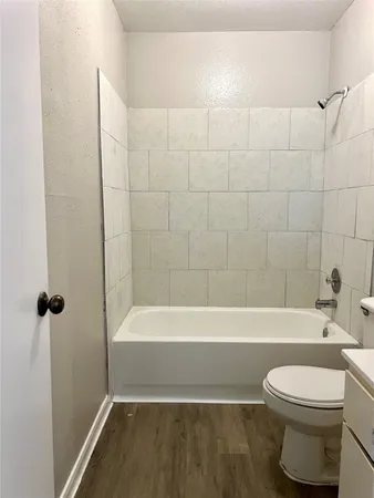a bathroom with a toilet and a bath tub