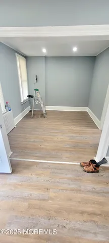 a view of a room with wooden floor