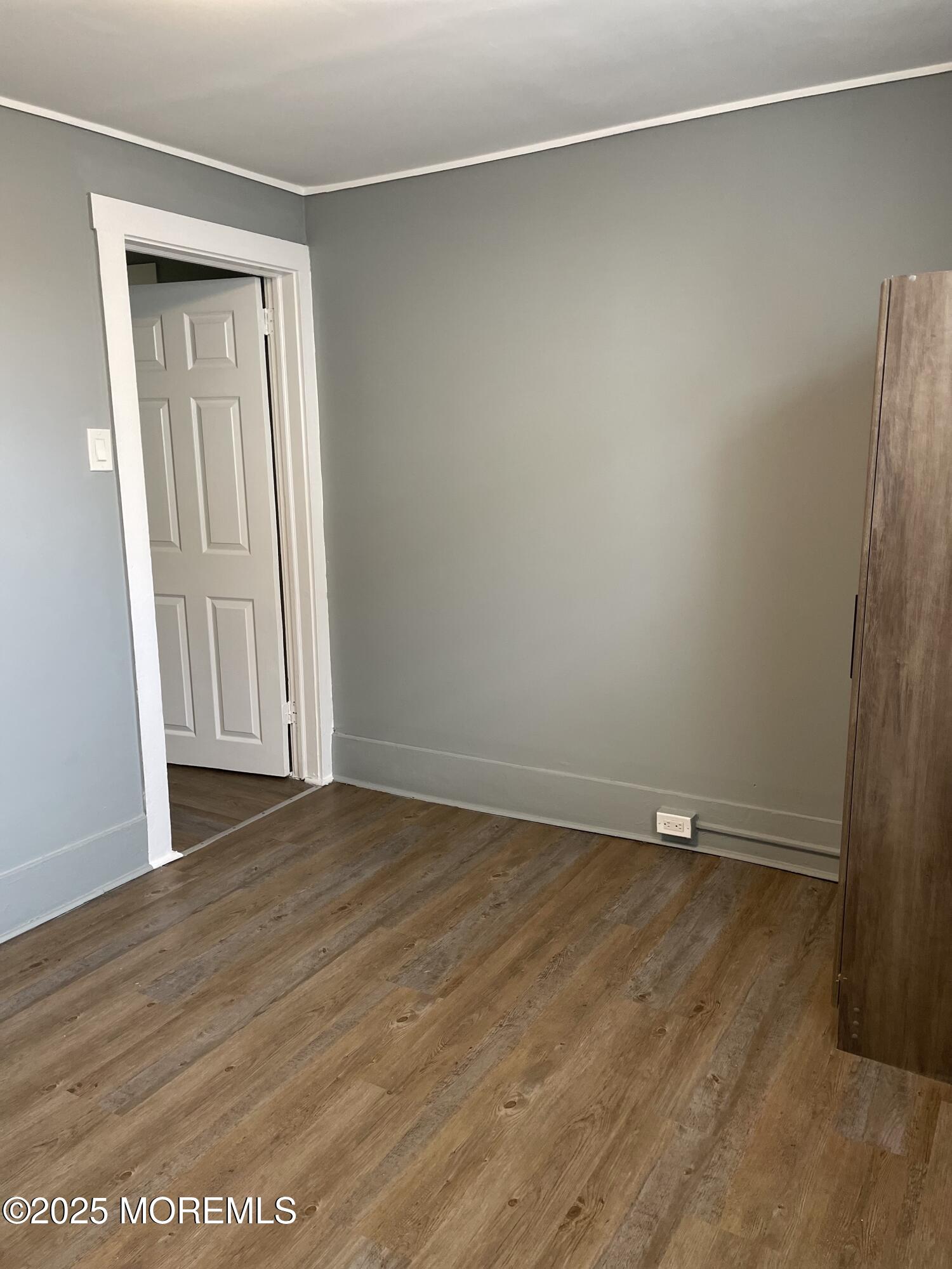 2402 Auburn Terrace, Unit B Atlantic City, NJ 08401 - Photo 6 of 6 a view of an empty room with wooden floor and a window