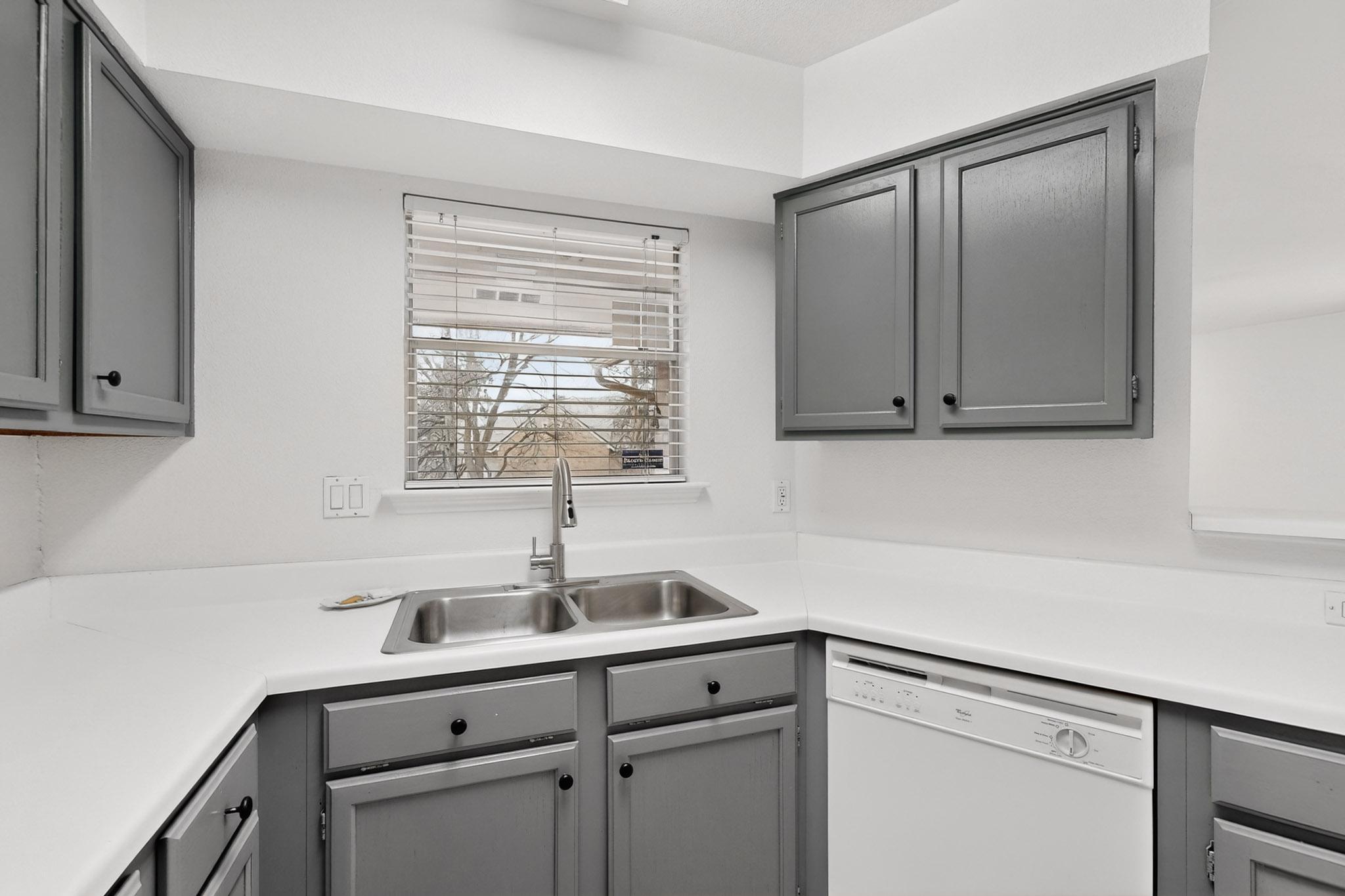 2450 Wickersham Lane, Unit 904 Austin, TX 78741 - Photo 12 of 35 a kitchen with a sink cabinets and window