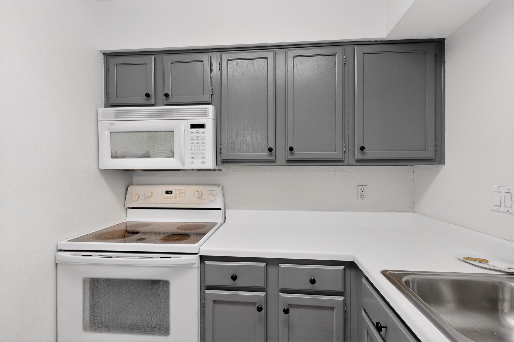 2450 Wickersham Lane, Unit 904 Austin, TX 78741 - Photo 13 of 35 a kitchen with a sink cabinets and appliances