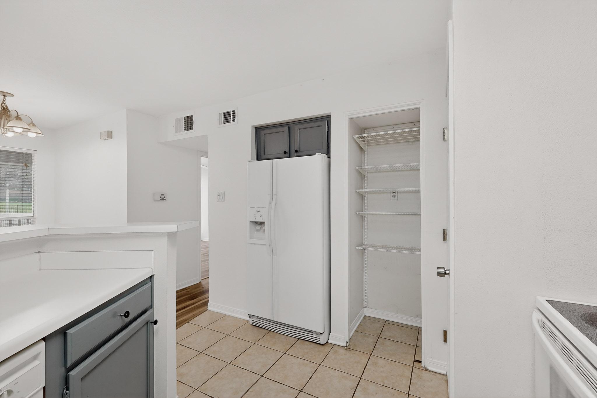 2450 Wickersham Lane, Unit 904 Austin, TX 78741 - Photo 14 of 35 a view of kitchen with white cabinets