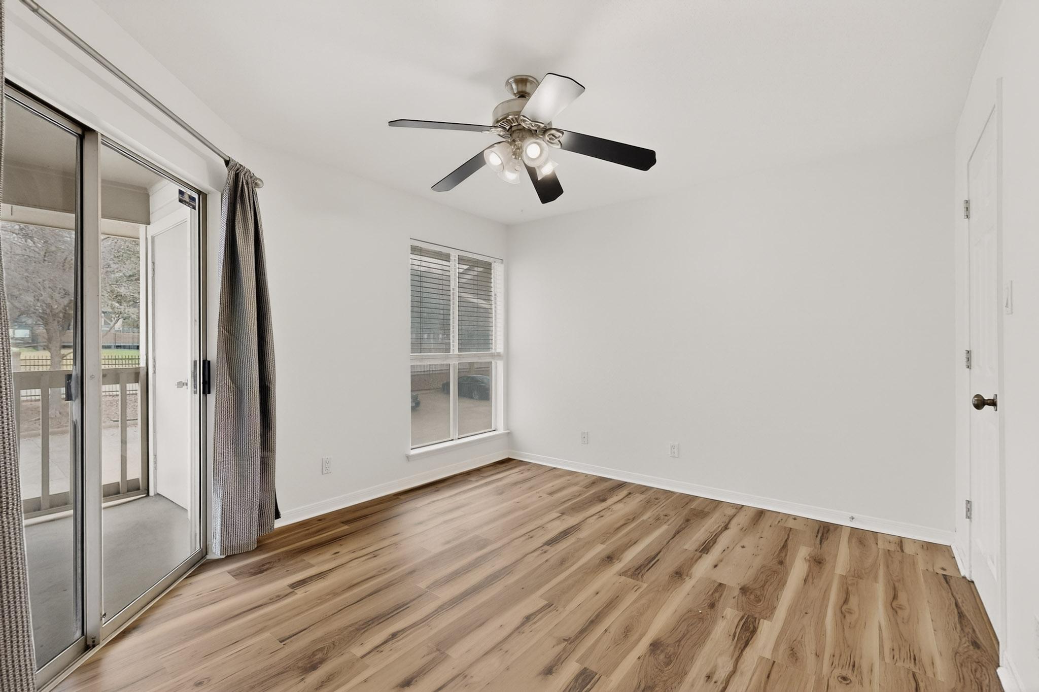 2450 Wickersham Lane, Unit 904 Austin, TX 78741 - Photo 16 of 35 a view of empty room with wooden floor and fan