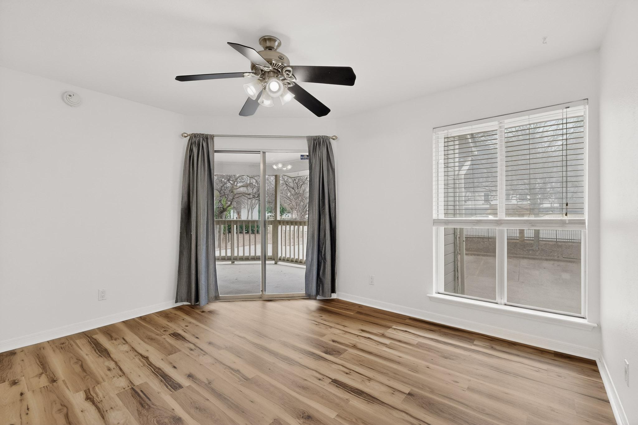 2450 Wickersham Lane, Unit 904 Austin, TX 78741 - Photo 17 of 35 a view of empty room with wooden floor and fan