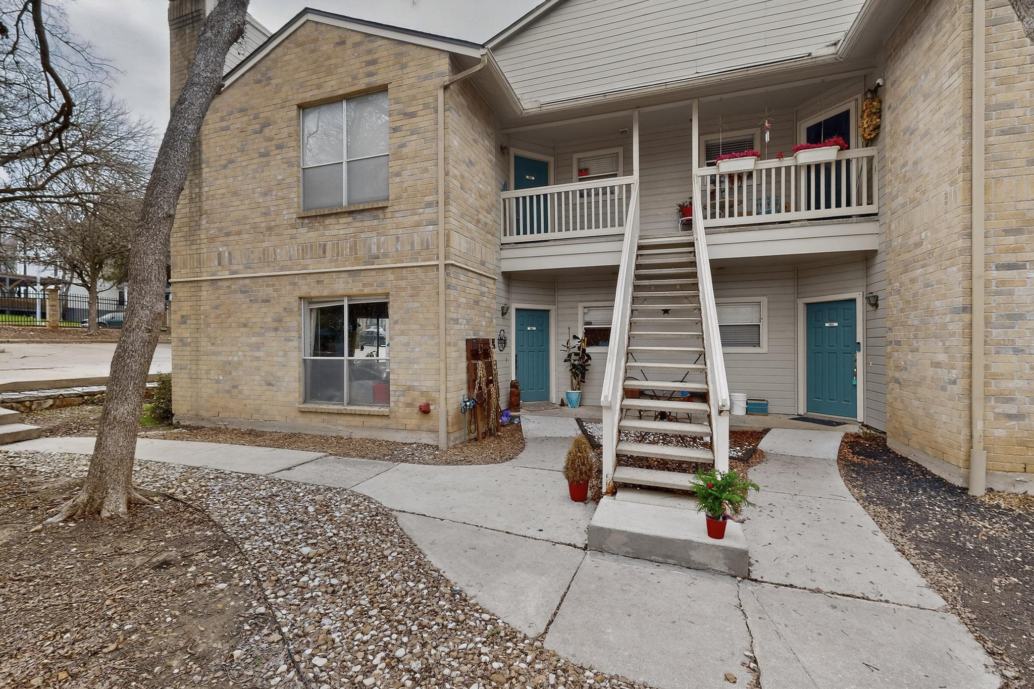 2450 Wickersham Lane, Unit 904 Austin, TX 78741 - Photo 30 of 35 a front view of a house with a yard