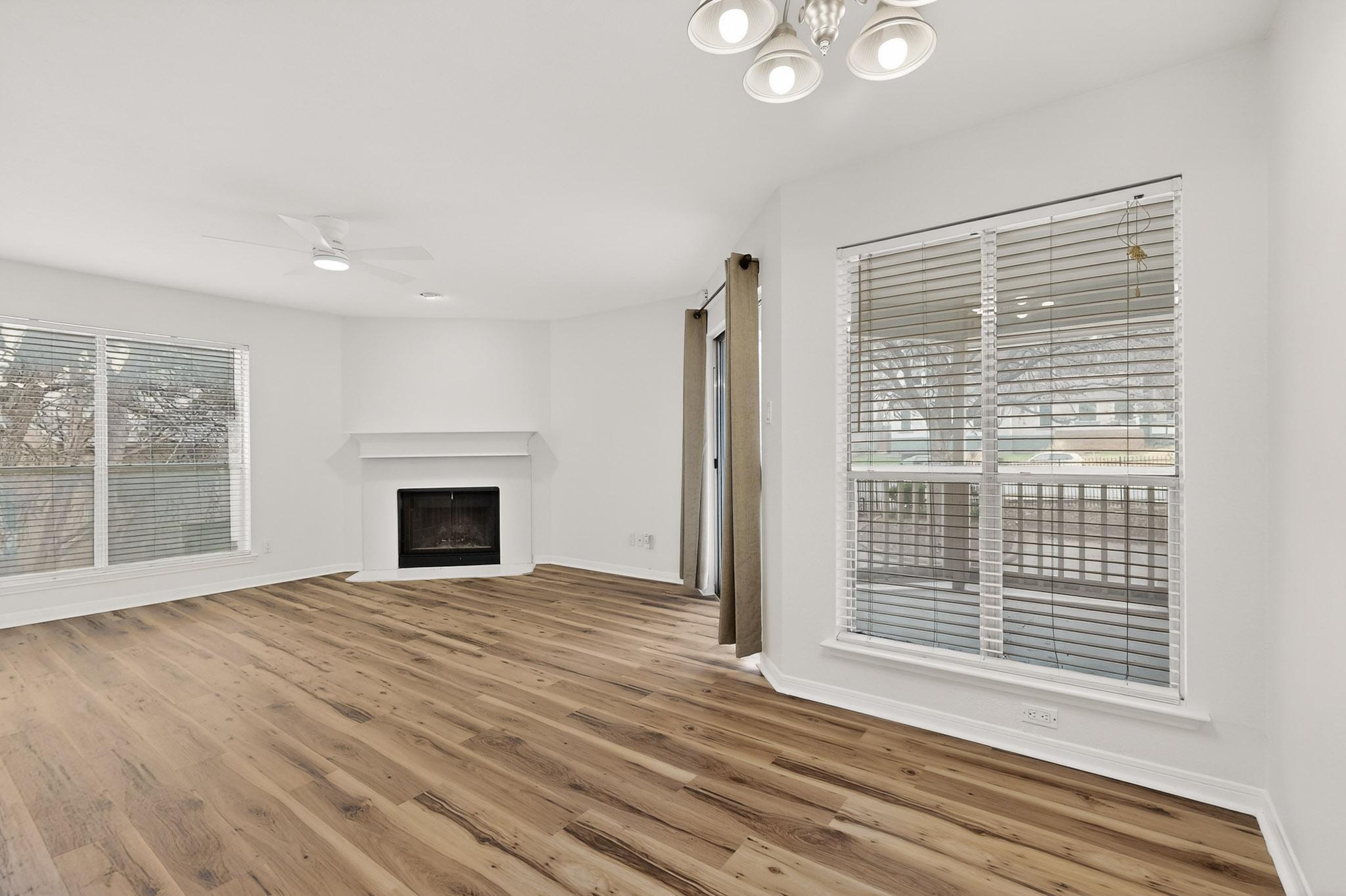 2450 Wickersham Lane, Unit 904 Austin, TX 78741 - Photo 8 of 35 a view of empty room with wooden floor and fireplace
