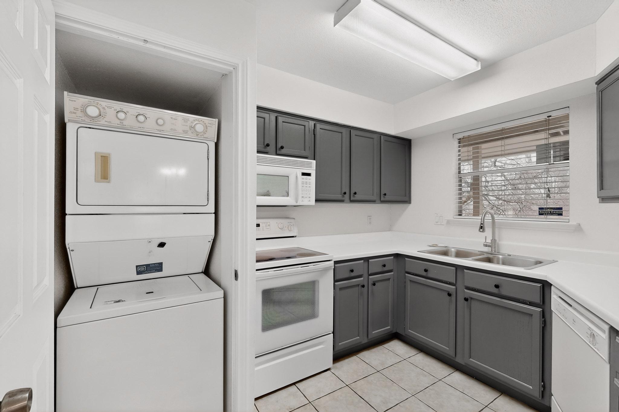 2450 Wickersham Lane, Unit 904 Austin, TX 78741 - Photo 10 of 35 a kitchen with a sink and cabinets