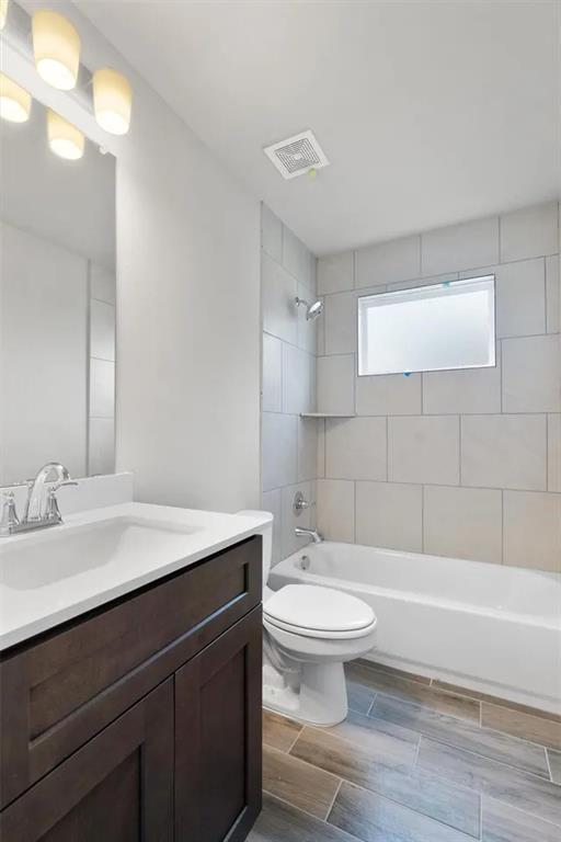 332 Stellar Wind Drive Georgetown, TX 78628 - Photo 23 of 29 A well-appointed bathroom features a dark wood vanity and a tiled bath/shower combination.