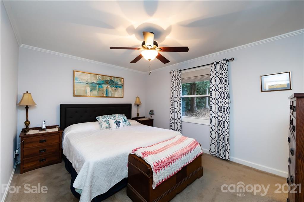 731 Lochridge Road Charlotte, NC 28209 - Photo 13 of 31 a bedroom with a bed and a chandelier
