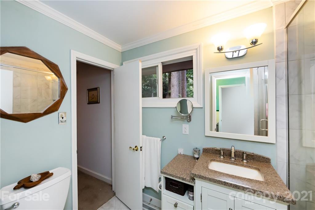 731 Lochridge Road Charlotte, NC 28209 - Photo 14 of 31 a bathroom with a sink and a mirror