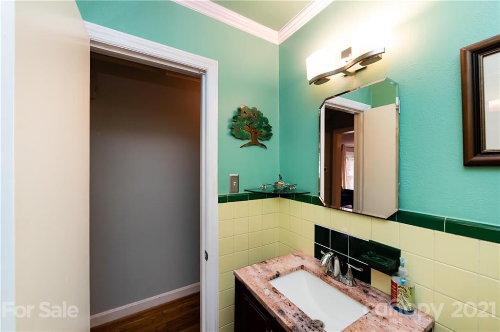 731 Lochridge Road Charlotte, NC 28209 - Photo 17 of 31 a bathroom with a sink and a mirror