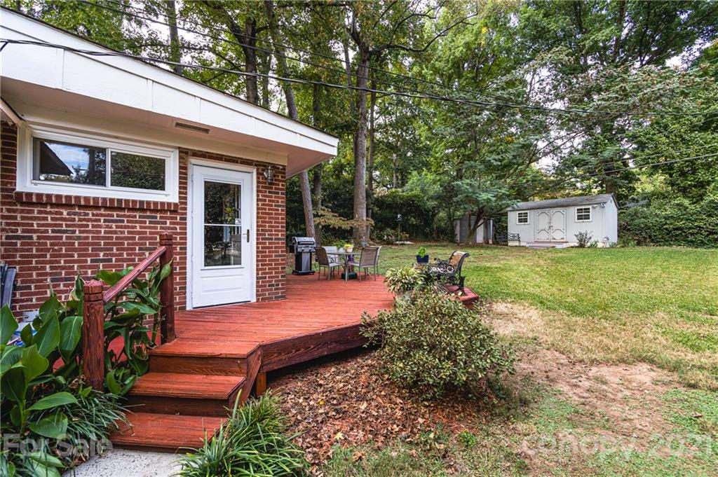 731 Lochridge Road Charlotte, NC 28209 - Photo 22 of 31 a view of a house with backyard garden and sitting area