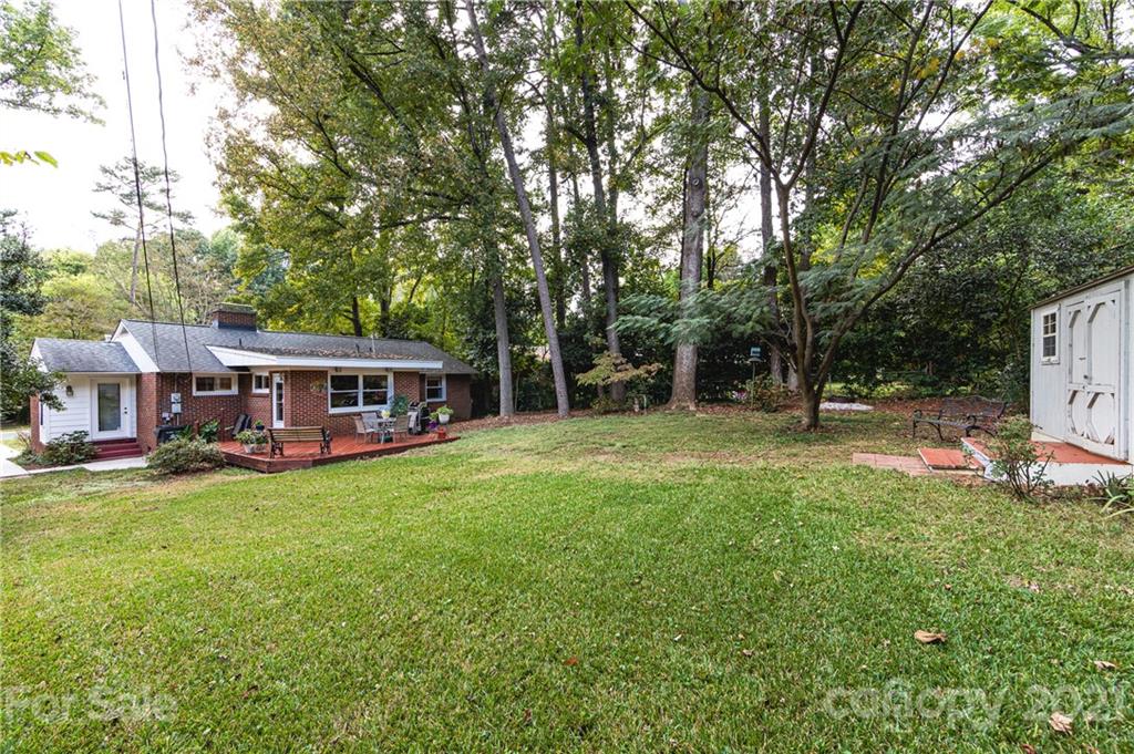 731 Lochridge Road Charlotte, NC 28209 - Photo 24 of 31 a view of a yard with large trees and a barn