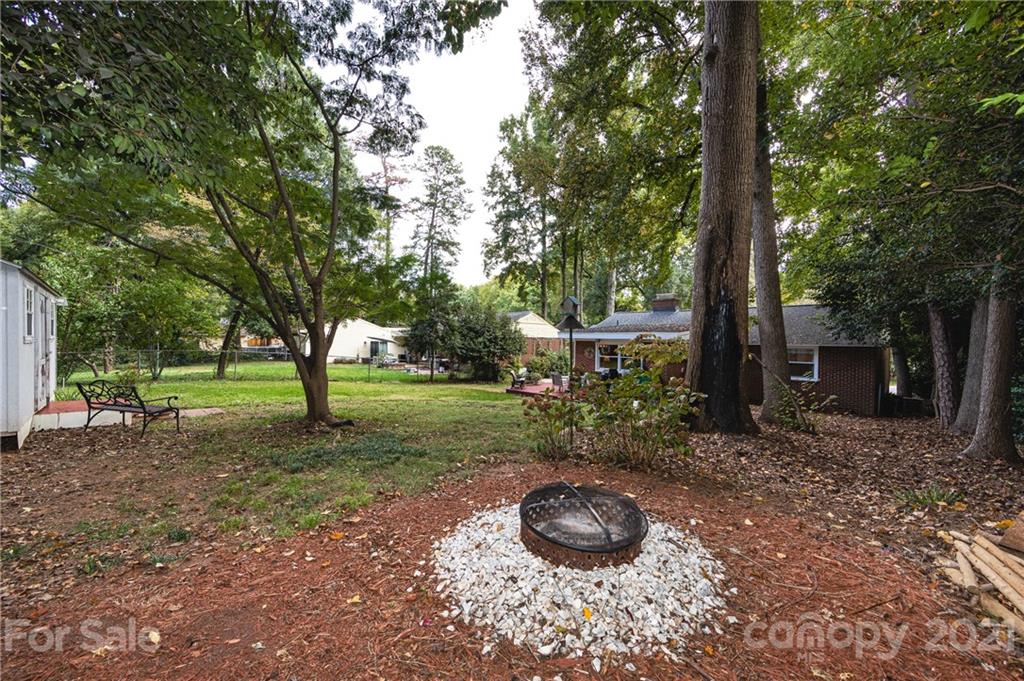 731 Lochridge Road Charlotte, NC 28209 - Photo 26 of 31 a view of a backyard with large trees