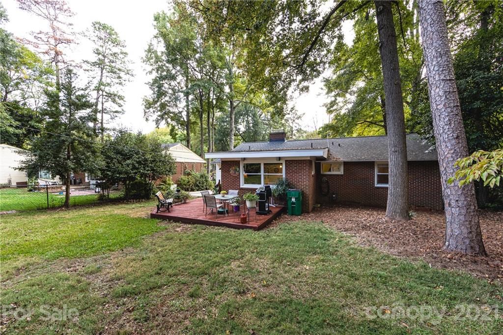 731 Lochridge Road Charlotte, NC 28209 - Photo 27 of 31 a view of a house with backyard sitting area and garden