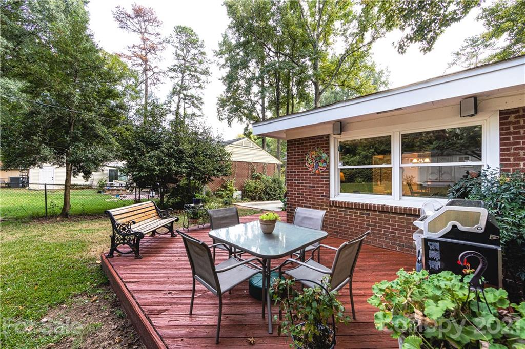 731 Lochridge Road Charlotte, NC 28209 - Photo 28 of 31 a view of a patio with table and chairs potted plants and a large tree