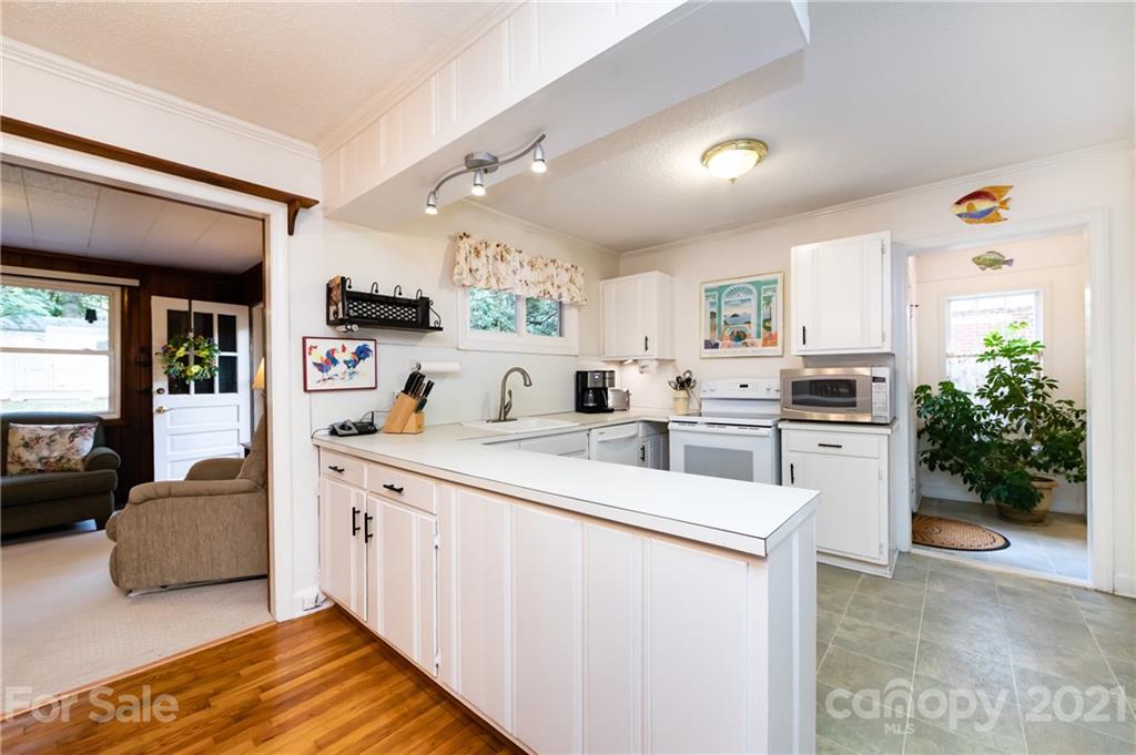 731 Lochridge Road Charlotte, NC 28209 - Photo 6 of 31 a kitchen with white cabinets and white appliances