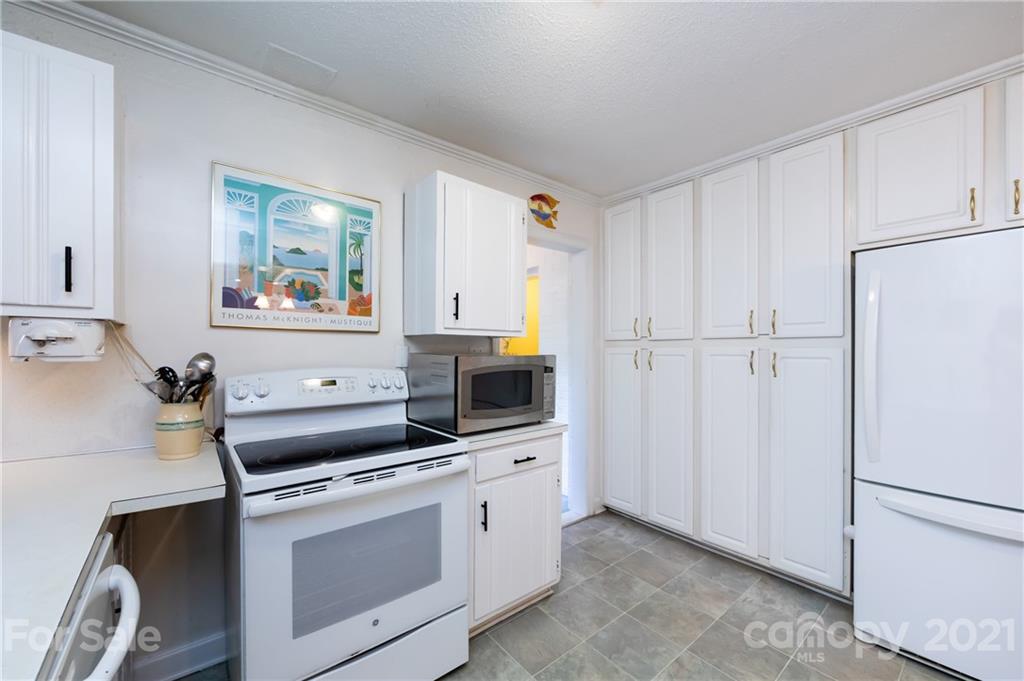 731 Lochridge Road Charlotte, NC 28209 - Photo 7 of 31 a kitchen with white cabinets and white appliances