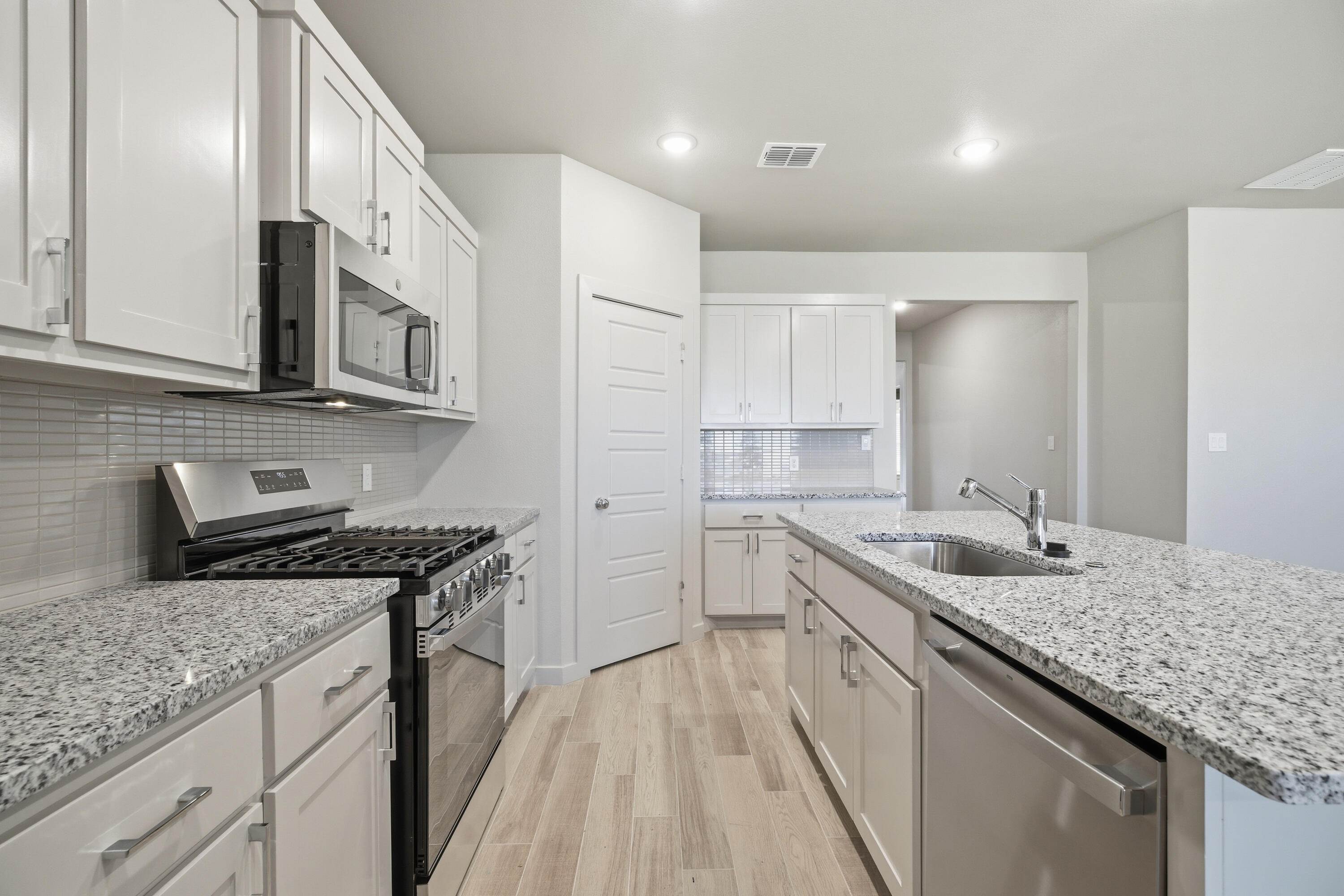 616 East 13th Street Wolfforth, TX 79382 - Photo 11 of 34 a kitchen with a sink stove and cabinets