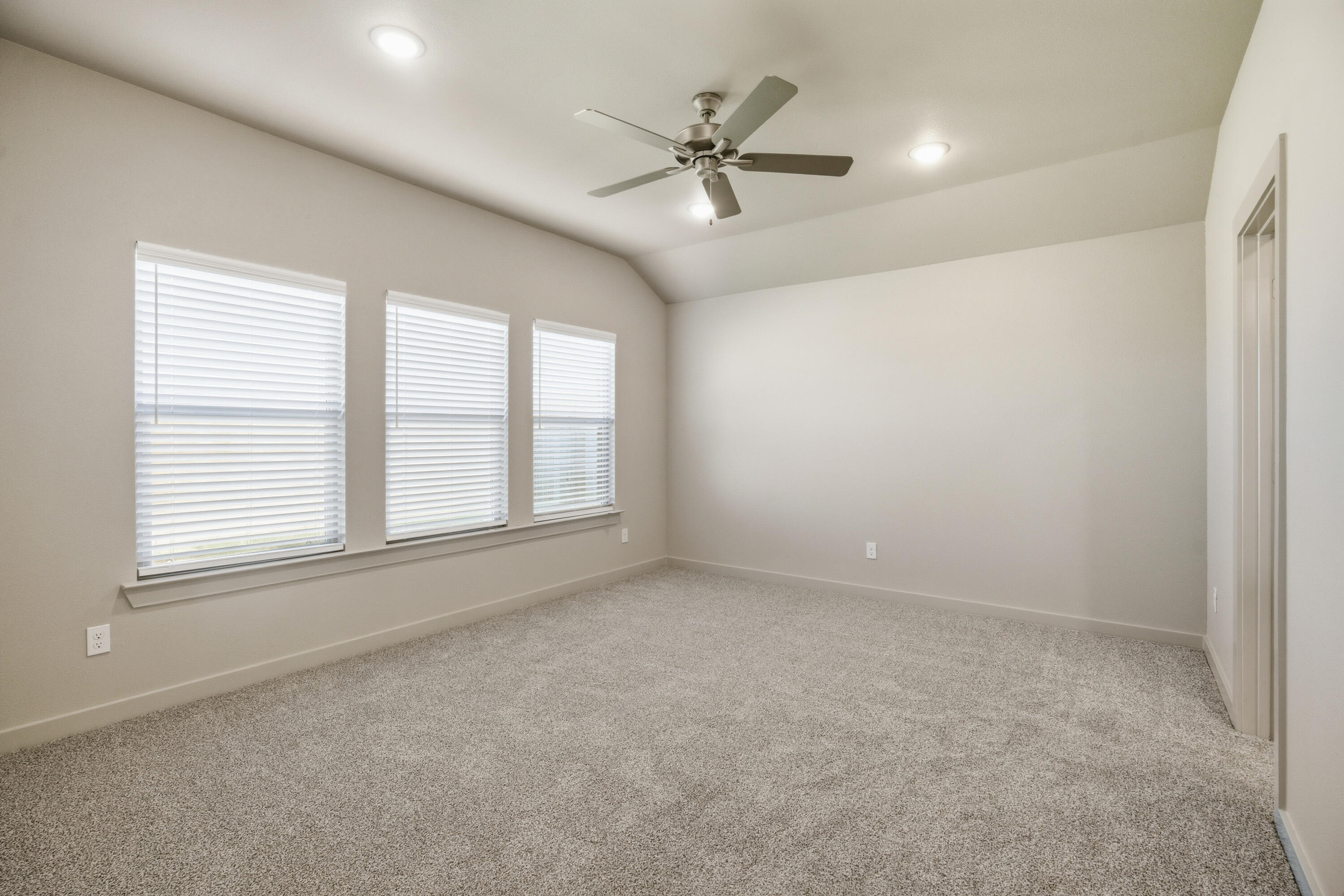 616 East 13th Street Wolfforth, TX 79382 - Photo 16 of 34 an empty room with a ceiling fan and windows