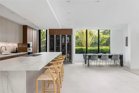 a bedroom with furniture and a large window