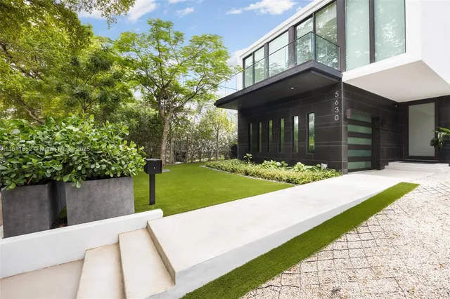 a view of a house with pool and sitting area