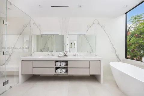 a view of a livingroom with furniture and floor to ceiling window