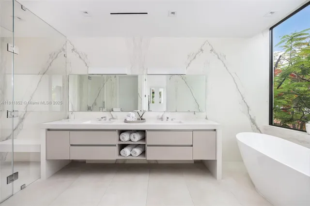 a view of a livingroom with furniture and floor to ceiling window