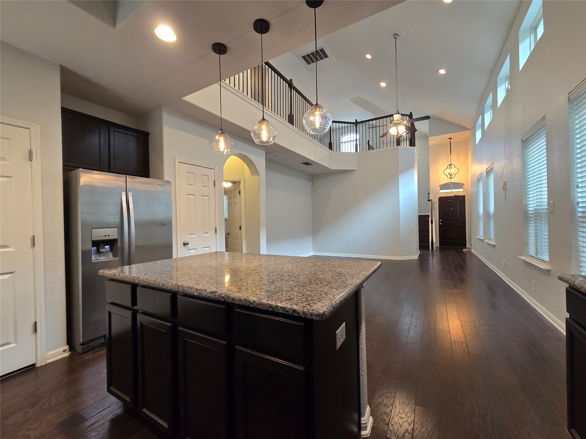 7337 Menchaca Road, Unit #22 Austin, TX 78745 - Photo 6 of 25 Kitchen featuring decorative light fixtures, ceiling fan, cabinets, a kitchen island, and stainless steel fridge with ice dispenser