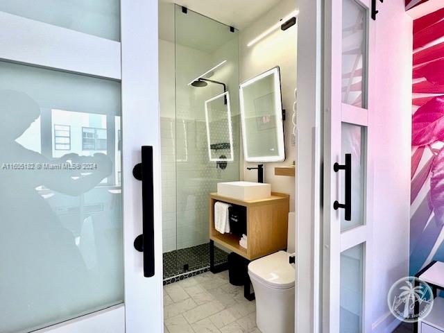 255 West 24th Street, Unit 308 Miami Beach, FL 33140 - Photo 13 of 31 a bathroom with a toilet and a shower