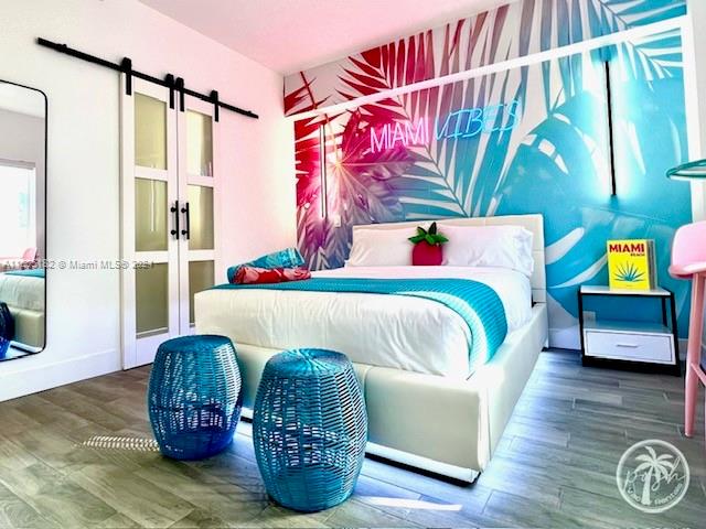 255 West 24th Street, Unit 308 Miami Beach, FL 33140 - Photo 16 of 31 a living room with furniture and a wooden floor