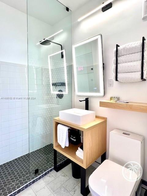 255 West 24th Street, Unit 308 Miami Beach, FL 33140 - Photo 23 of 31 a bathroom with a sink a toilet and shower